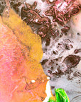 Close-up of colorful abstract painting with orange, pink, and green hues by Finnish artist Lotta Sirén