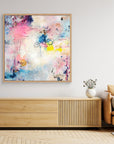 UFO (& other flying vehicles) - Canvas Print A semi-abstract canvas print with oak framea wall on top of a TV-stand. A light piece with off-white, pastel tones and blue, pink and yellow hues.  