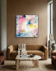 UFO (& other flying vehicles) - Canvas Print. A semi-abstract canvas print with black frame on a modern living room wooden wall. A light piece with off-white, pastel tones and blue, pink and yellow hues.  Modern living room with a colorful abstract painting. 