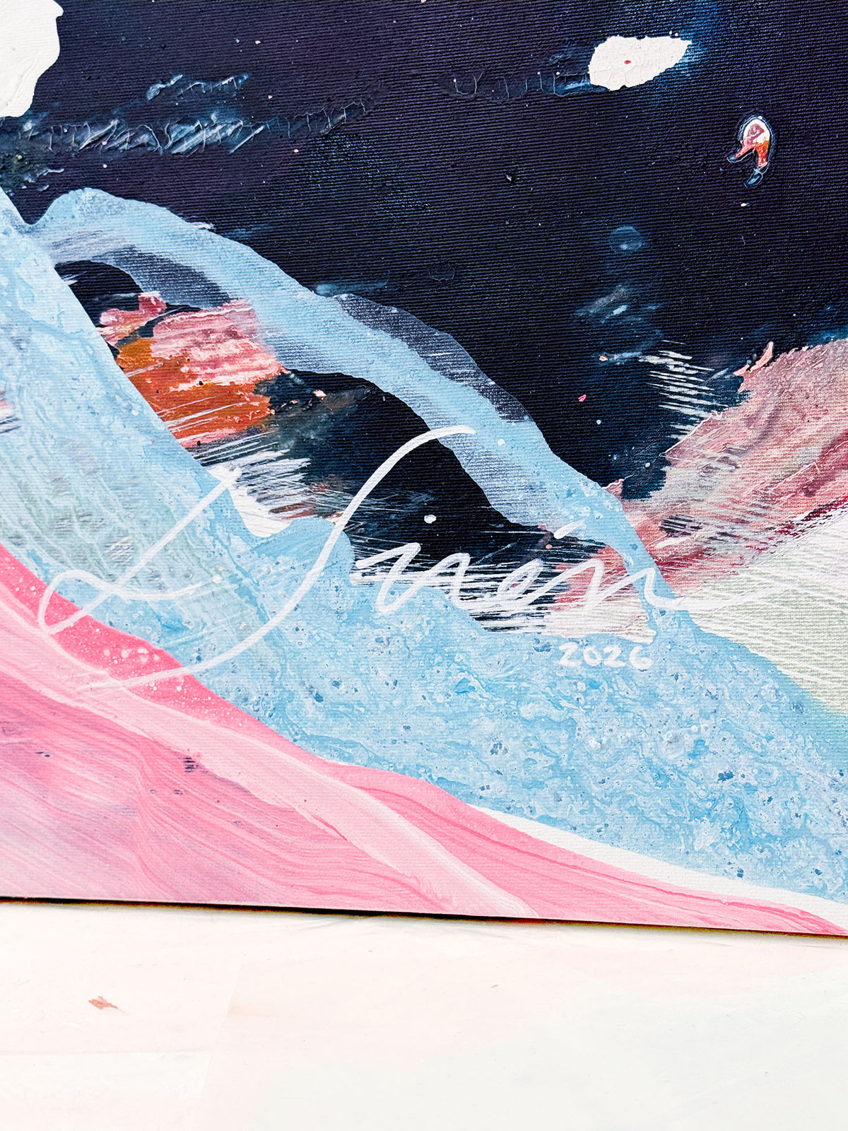 Abstract painting on canvas featuring dark navy and pink with a visible artist signature Lotta Sirén.