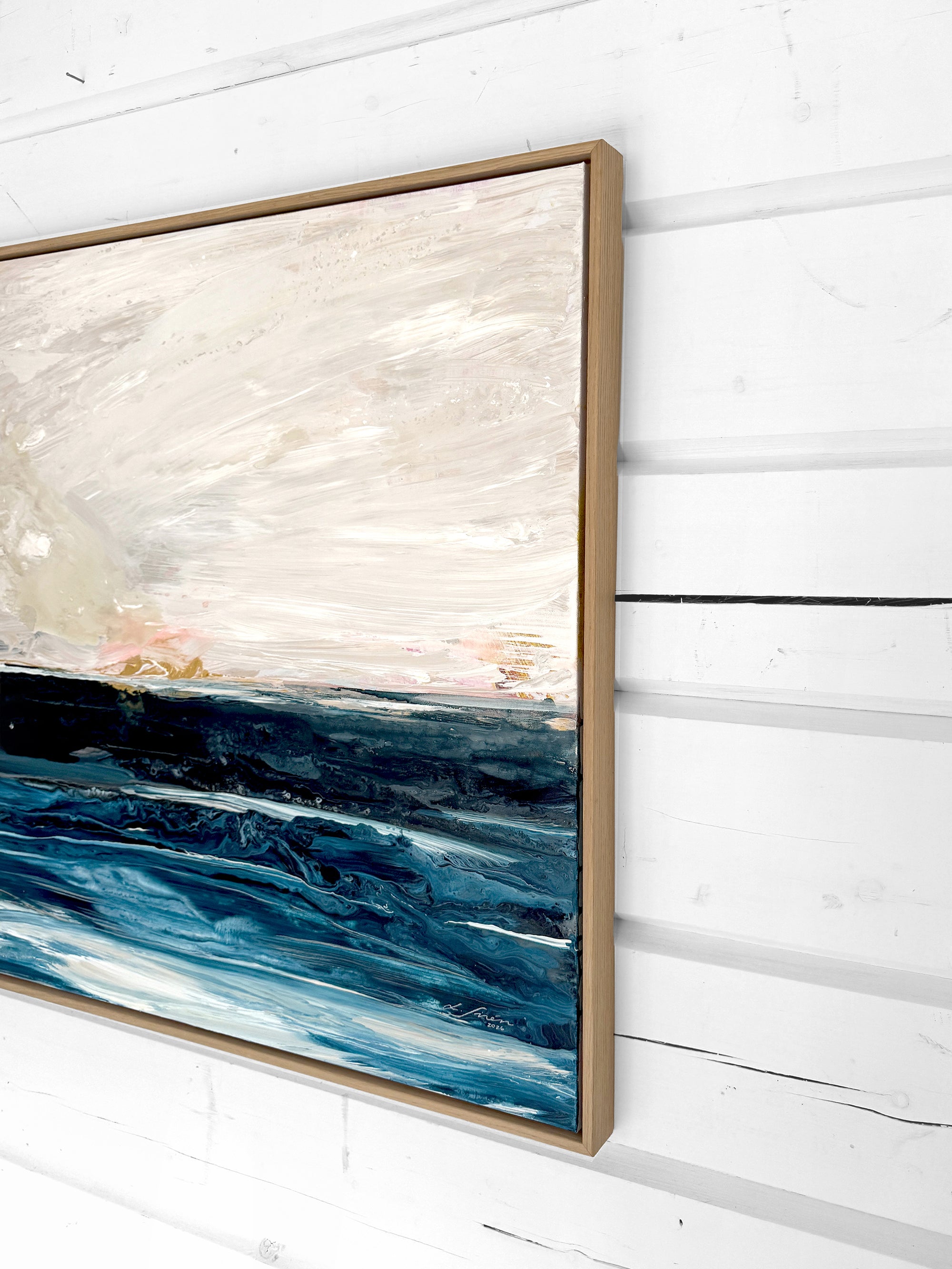 Abstract painting with blue and beige tones on a white wall by Finnish abstract artist Lotta Sirén