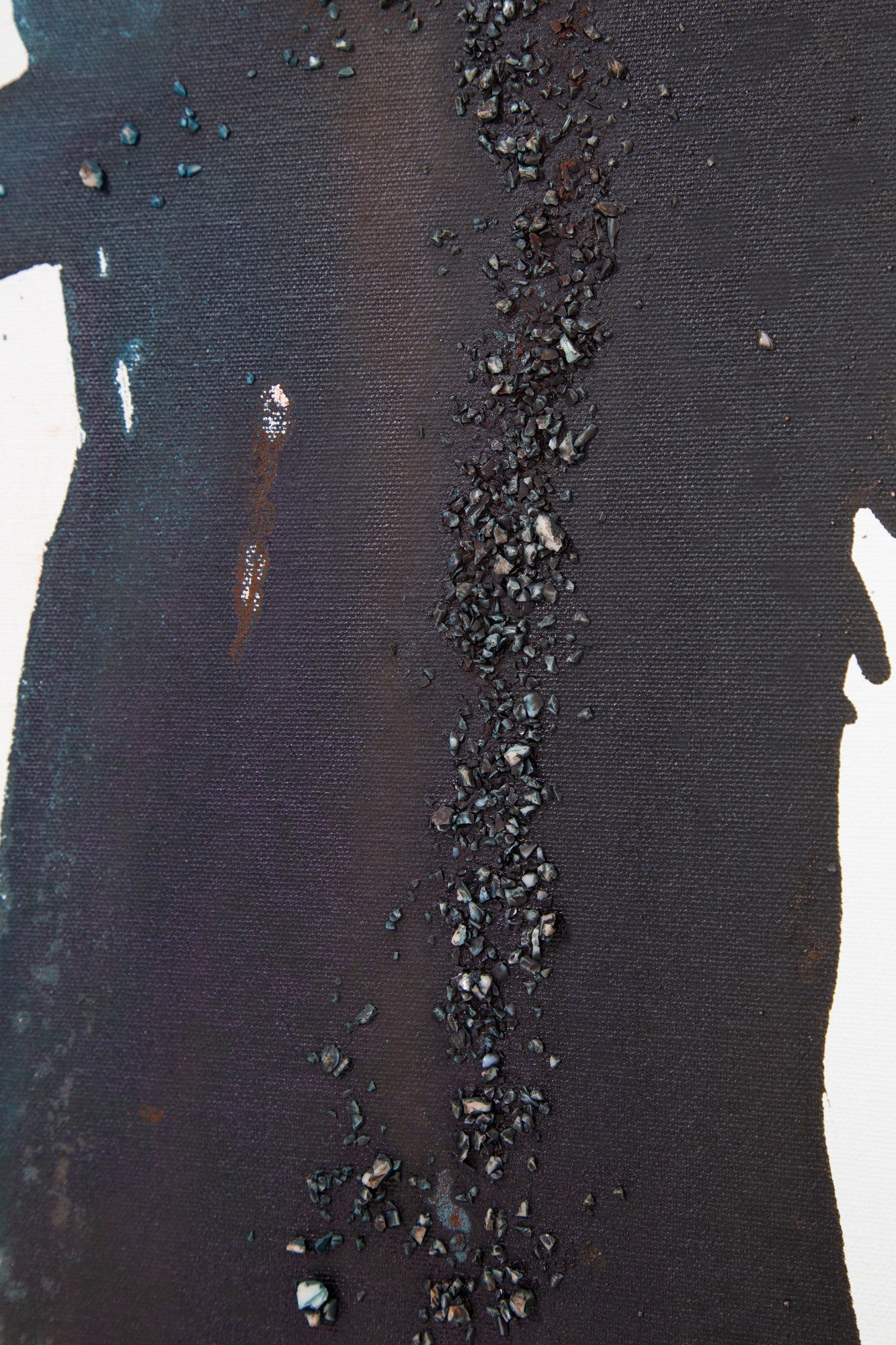 Close-up of a textured black surface with small texture on an abstract painting