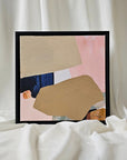 Framed abstract art piece on a white surface