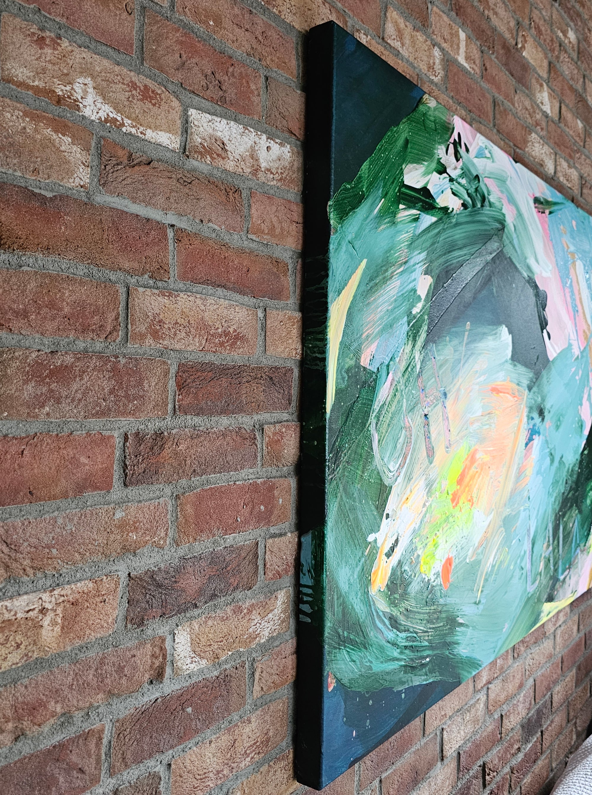 Abstract painting leaning against a brick wall by Lotta Sirén