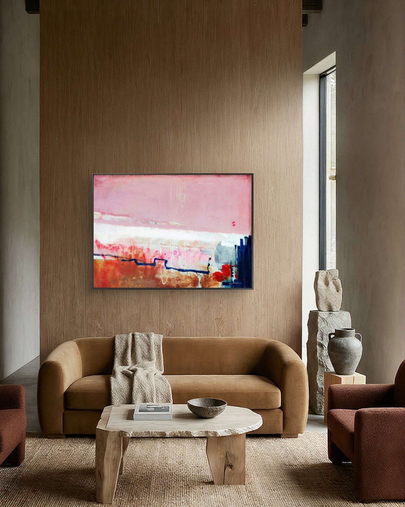 Detours Approved - Limited Edition Canvas Print with black frames on a living room wall above a tv stand.  Piece with pink, white and burnt sienna tones and a hint of red &amp; blue. Modern living room with a brown sofa, abstract painting, and decorative items.