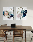 Modern office space with a wooden desk, chairs, and abstract flower wall art.
