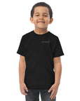 Child wearing a black t-shirt with 'MASTERPIECE' logo Lotta Sirén Art  shirt on a white background