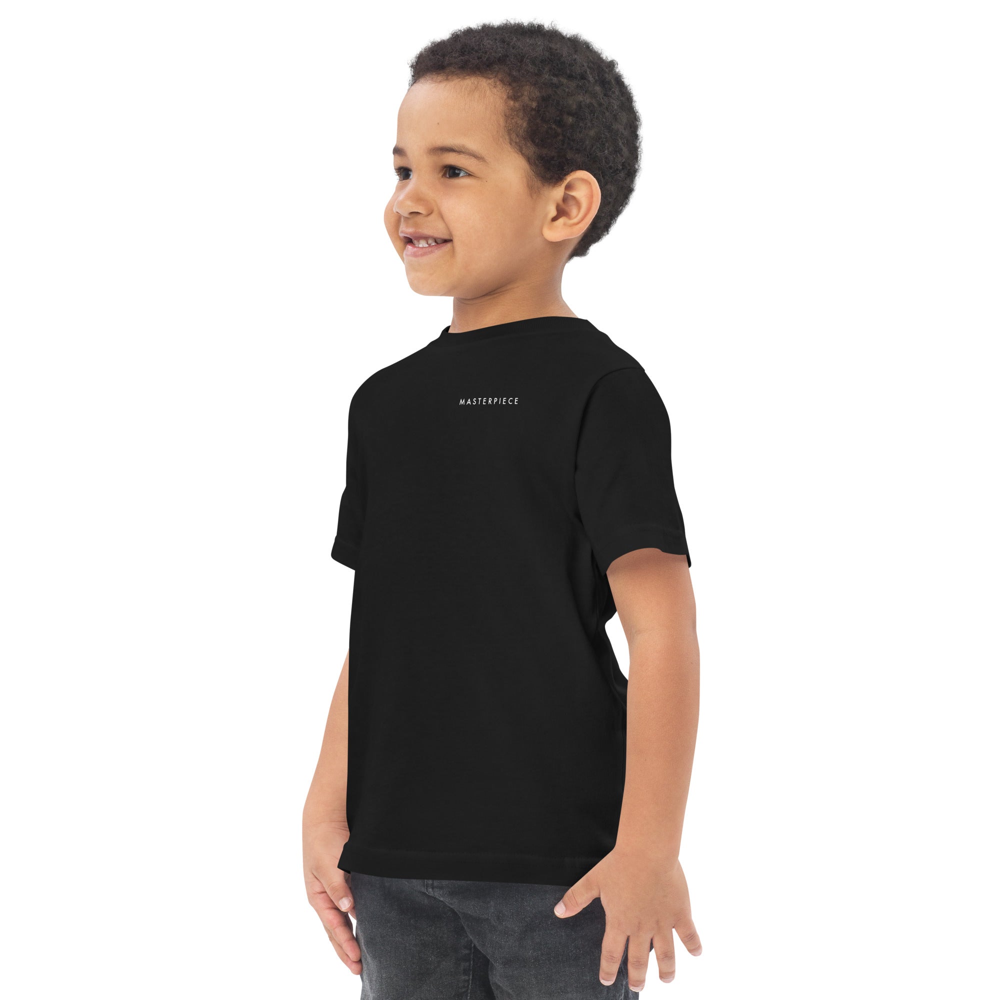 Child wearing a black t-shirt with 'MASTERPIECE' logo Lotta Sirén Art shirt on a white background